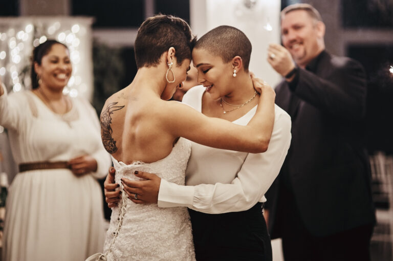 shot-of-a-newlywed-couple-dancing-while-being-surr-2022-12-08-23-03-23-utc